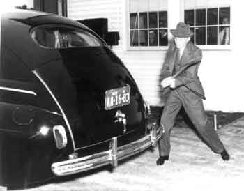 Henry Ford swinging an axe at his 1941 car to demonstrate the toughness of the plastic trunk door made of soybean and hemp. (From the collections of Henry Ford Museum & Greenfield Village.)
