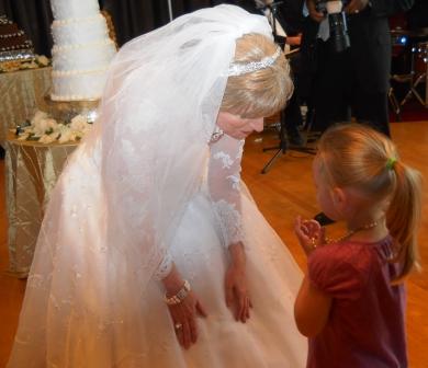 Dr. Carolyn Nickell takes time to listen to a young wedding guest 