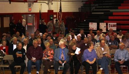 Veterans and family members wait as colors presented
